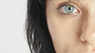 Half face beautiful woman with blue eyes